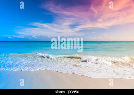 Tropical beach background, white sand and azure shore water under cloudy blue sky. Caribbean Sea coast, Dominican republic, Saona island. Tonal correc Stock Photo