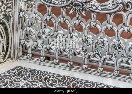 Pattern detail on a wrought iron bench in a park. Stock Photo