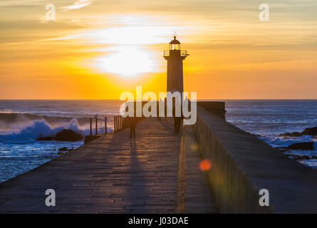 Felgueiras Lighthouse during sunset over Atlantic Ocean in Foz do Douro district of Porto city, second largest city in Portugal Stock Photo