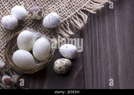 Easter eggs in the nest on burlap Stock Photo