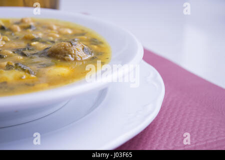 White dish with stew prepared for eating Stock Photo