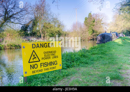 A sign indicating that no fishing is allowed on a section of The river Kennet because of overhead power lines. Stock Photo