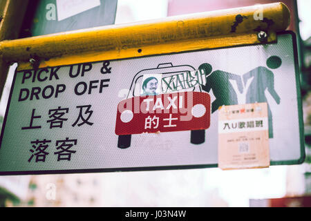 HONG KONG, CHINA - NOVEMBER 22, 2016: A signboard in the street meaning taxi pick up and drop off. Horizontal outdoors shot. Stock Photo