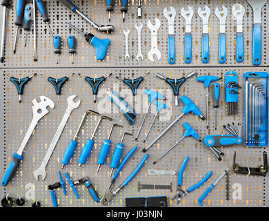 Stand with set tools on bicycle workshop Stock Photo