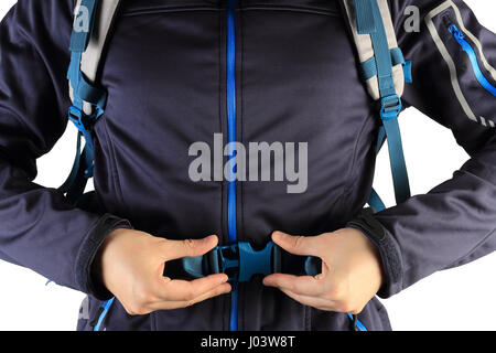 Man trying on parachute before jumping. Traveler fasten backpack isolated on white background. Man in blue jacket with backpack close-up. Extreme spor Stock Photo