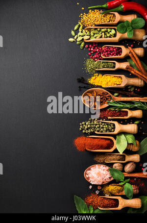 Background with various spices on black slate. Top view Stock Photo