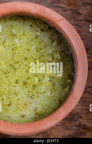 Traditional Polish sour gherkin soup served in a clay bowl. Stock Photo