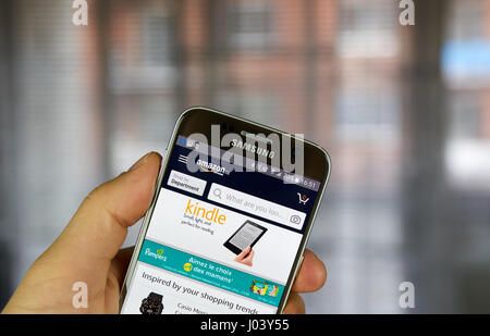 MONTREAL, CANADA - MARCH 20, 2017 - Amazon mobile application on screen of Samsung S5 in hand. Amazon is an American electronic commerce and cloud com Stock Photo