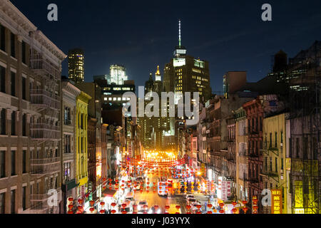 NEW YORK CITY - FEBRUARY 24th 2017: The colorful streets of Chinatown light up with cars, shops and people during a busy weekend night in downtown Man Stock Photo