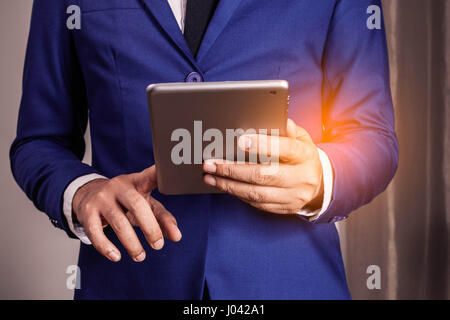 Businessmen are using a tablet in the office. Stock Photo