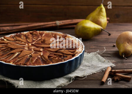 Fresh pear pie with spieces on a wooden background Stock Photo