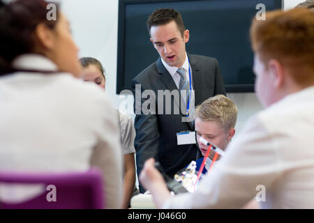 Teacher helping his students during a design and technology lesson. Stock Photo