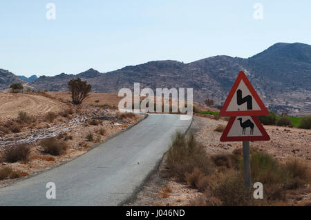 Jordan: a camel crossing triangular warning sign on the road that links the Dana Biosphere Reserve to the city of Petra Stock Photo