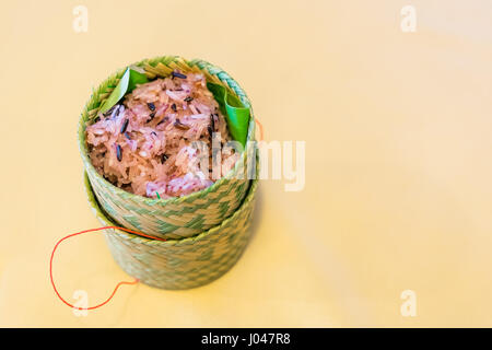 Dark sticky rice inside bamboo container. Cooked glutinous rice or sticky rice. Stock Photo