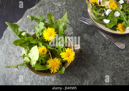 Yellow dandelion flowers in a vintage copper cup isolated Stock Photo