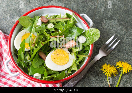 Dandelion egg salad with onions and cheese in a bowl Stock Photo