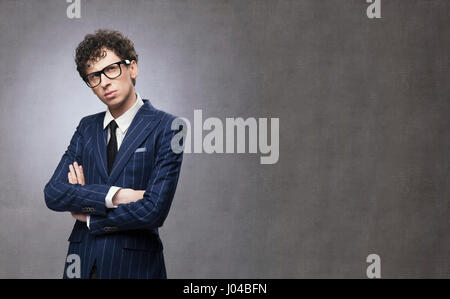 Portrait of a young businessman thinking and looking up Stock Photo