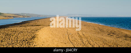 Looking west along Chesil Beach to the Isle of Portland from Abbotsbury on a sunny evening on Dorset's Jurassic Coast. Stock Photo