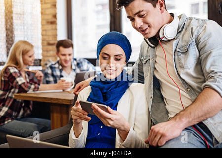 Positive delighted students resting in the cafe Stock Photo
