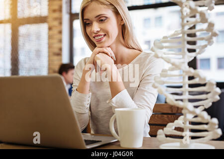 Cheerful young woman sitting in the cafe Stock Photo