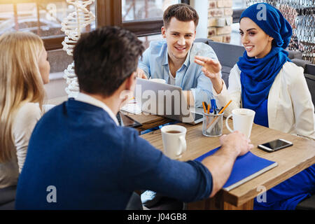 Positive international students studying together Stock Photo