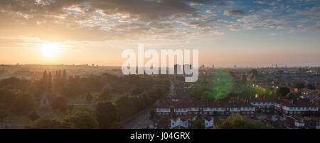 Sunset over terraced houses and the Lambeth Cemetery at Blackshaw Road in Tooting, south west London. Stock Photo