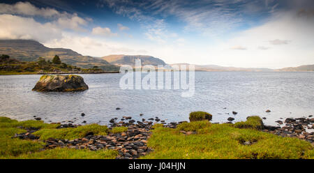 Mountains rise from the rocky shores of Loch Torridon, a sea loch in the north west Highlands of Scotland. Stock Photo