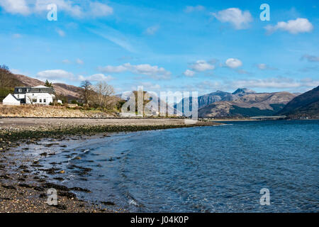 View from Scottish village Onich across Loch Linnhe towards the Glen Coe mountains with Bidean nam Bian in Highland Scotland UK with Onich Hotel left Stock Photo