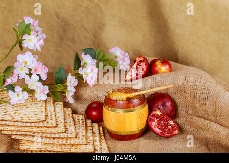 Pomegranate and glass of red wine close-up on mat. Stock Photo