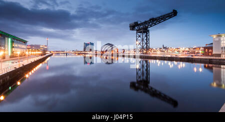 Glasgow, Scotland, UK - January 9, 2011: The iconic Finnieston Crane is reflected in the River Clyde at sunset in the former docklands of Glasglow, al