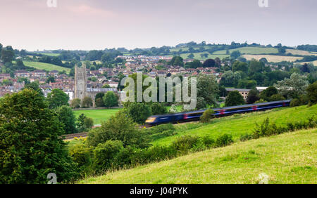 Bruton, England, UK - July 26, 2012: A First Great Western Intercity 125 high speed passenger train passes the church and town of Bruton, Somerset. Stock Photo