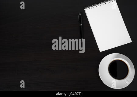 Coffee cup and notepad on wooden table with copy space Stock Photo