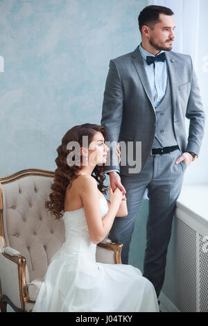 A woman holding a man's hand. Bride in beautiful dress and groom Stock Photo