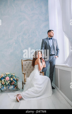 A woman holding a man's hand. Bride in beautiful dress and groom Stock Photo