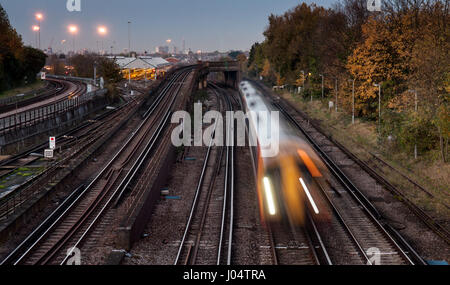 London, England, UK - November 11, 2012: A South West Trains Class 158 diesel passenger train passes Wimbledon flyover on the South West Main Line. Stock Photo