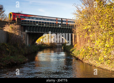 London, England, UK - November 18, 2012: South West Trains Class 159 diesel passenger trains cross the River Wandle at Earlsfield in Wandsworth. Stock Photo