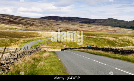 The two-lane B6276 road meanders through rolling moorland in Teesdale, County Durham, in England's North Pennines. Stock Photo