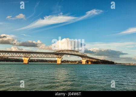 Auckland Harbour Bridge and sunlit clouds. Stock Photo