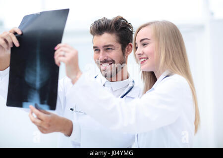 Closeup portrait of intellectual healthcare professionals with white labcoat, looking at full body x-ray radiographic image Stock Photo