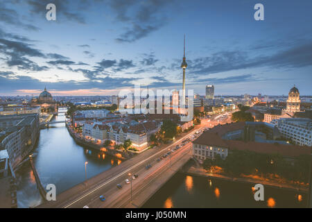 Classic aerial view of Berlin skyline with famous TV tower and Spree river in beautiful post sunset twilight during blue hour at dusk