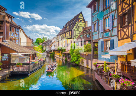 Beautiful view of the historic town of Colmar, also known as Little Venice, with tourists taking a boat ride along colorful houses, Alsace, France Stock Photo