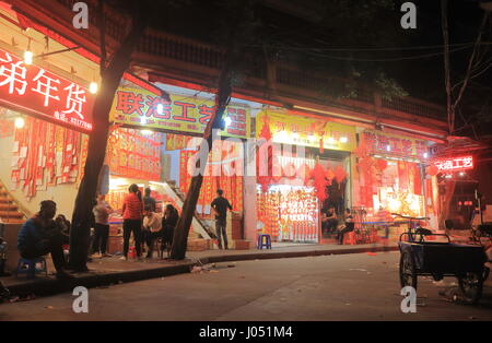 People shop Chinese fortune hanging display for Chinese New Year in Guangzhou China. Stock Photo