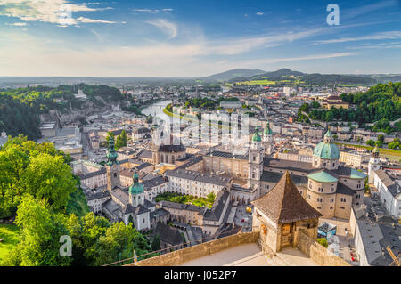 Aerial panoramic view of the historic city of Salzburg with Salzach river in beautiful golden evening light with blue sky and clouds at sunset Stock Photo