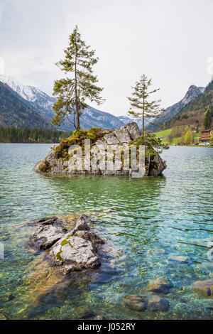 Beautiful scene of trees on a rock island in idyllic scenery at charming Lake Hintersee, Nationalpark Berchtesgadener Land, Upper Bavaria, Germany Stock Photo