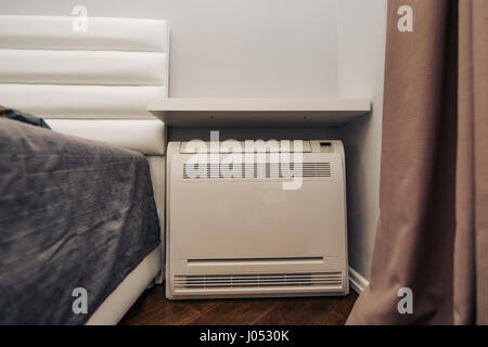 Square air conditioner in the apartment. On the floor, split system. Stock Photo