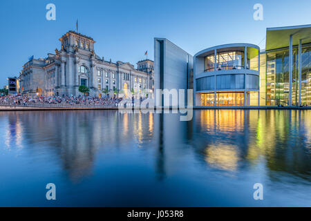 Panoramic view of modern Berlin government district with famous Reichstag building and Spree river illuminated in beautiful post sunset twilight Stock Photo