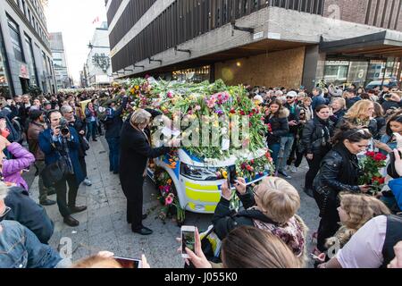 Stockholm, Sweden. 9th Apr, 2017. Flowers are seen on a police car as people offer their condolences for the victims of the truck attack in Stockholm, Sweden, April 9, 2017. A truck rammed into people on a central Stockholm street before crashing into a department store on Friday, killing four and wounding 15 others. Nine wounded people are still hospitalized. Credit: Shi Tiansheng/Xinhua/Alamy Live News Stock Photo
