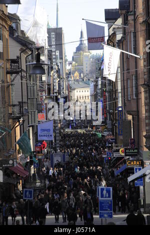 Drottninggatan (& Kammakargatan) street view in daytime, looking down to Stockholm's Ahlens shopping mall, marking the second turn to the left of the deadly route towards the city, where the  truck attacker terrorist left behind 5 dead people, one dead dog named Iggy and 16 people injured seriously. Stockholm city, Sweden. 9 April 2017. Stock Photo