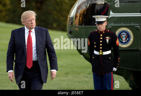 Washington, USA. 9th Apr, 2017. United States President Donald Trump walks on the South Lawn of the White House after disembarking from Marine One in Washington, DC, April 9, 2017. Credit: MediaPunch Inc/Alamy Live News Stock Photo