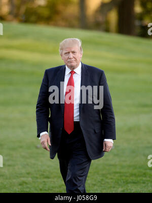 Washington, USA. 9th Apr, 2017. United States President Donald Trump walks on the South Lawn of the White House after disembarking from Marine One in Washington, DC, April 9, 2017. Credit: MediaPunch Inc/Alamy Live News Stock Photo